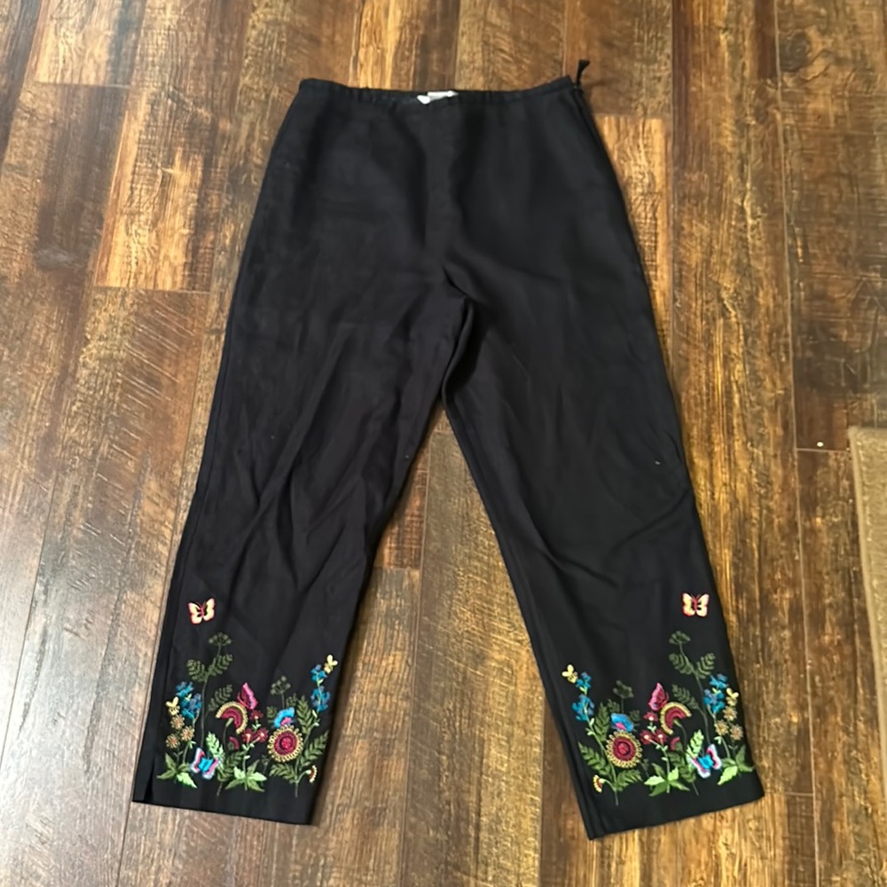 Women’s black ankle length pants, embroidered at bottom with flowers, size 8.